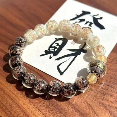 Leuchtendes Glücksarmband aus Goldfolie und Glas mit drehbaren Perlen