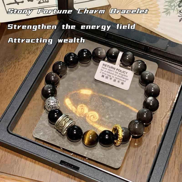 Obsidian bead protection bracelet with silver-tone charm and gold accent beads