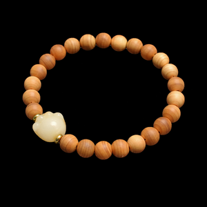 Wood bead bracelet with white cat paw charm and small gold-tone spacers